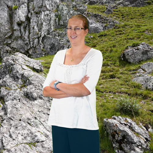 Close-up of Dr. Andrea Gall, outdoors, in a white shirt, smiling.