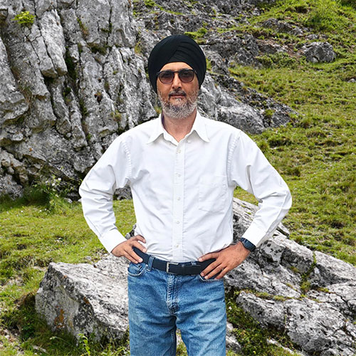 Close-up of Harpreet Walia, outdoors, in a white shirt.