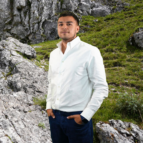 Close-up of Carlos Martinez, outdoors, in a white shirt.