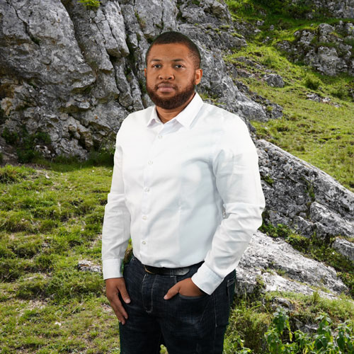 Close-up of Henry Nwokedi, outdoors, in a white shirt.