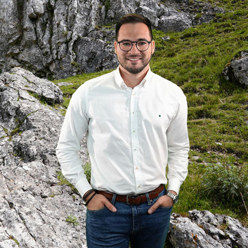 Close-up of Matias Carrillo, outdoors, in a white shirt, smiling.