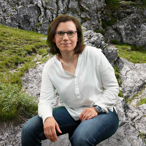 Close-up of Dr. Sandra Mahr, outdoors, in a white shirt, smiling.