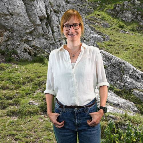 Close-up of Dr. Tina Seitz, outdoors, in a white shirt, smiling.