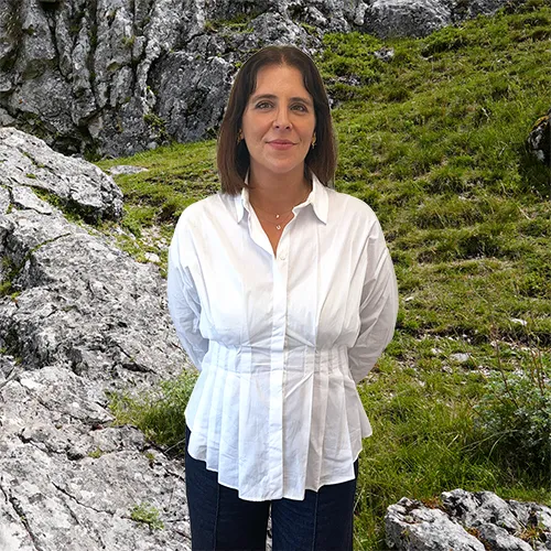 Close-up of Catarina Dias, outdoors, in a white shirt, smiling.